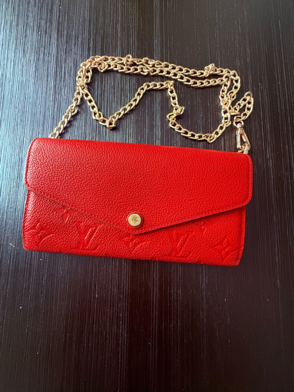 LOUIS VUITTON
Cerise Monogram Empreinte Leather Sarah NM Wallet